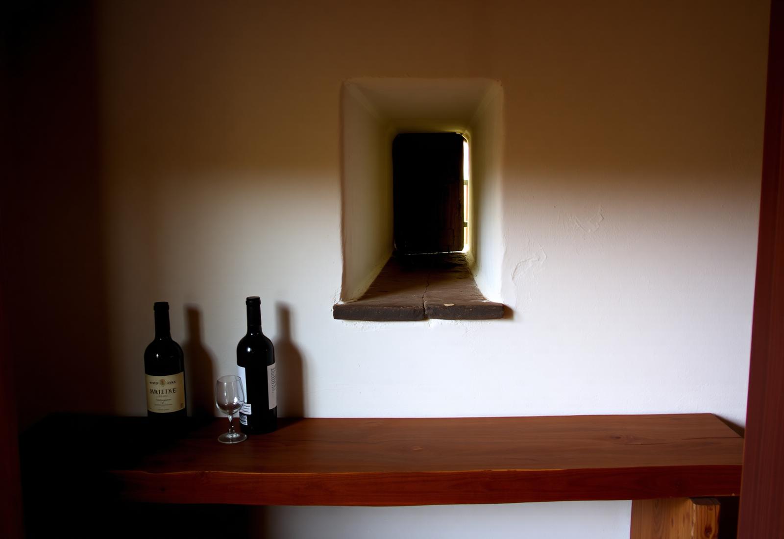 Tasting bench inside the whitewashed cellar